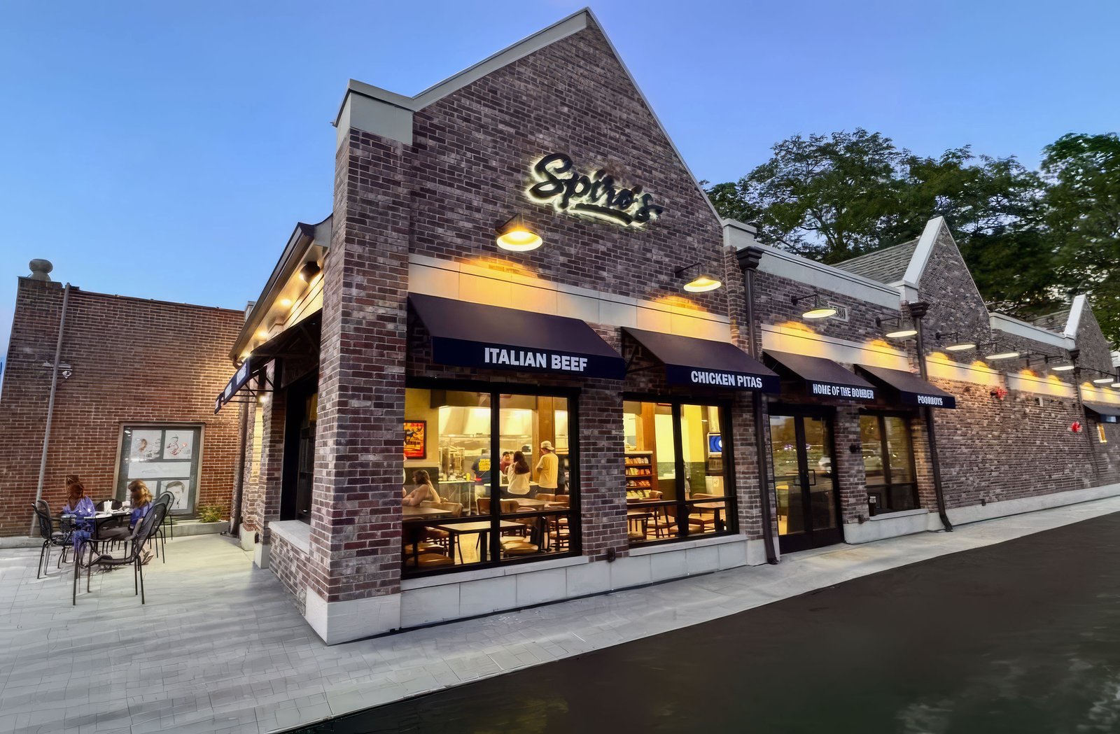 Spiro's Deli's new brick storefront at 1880 Glenview Road at dusk